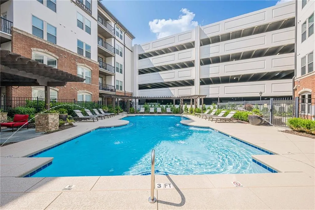 Community pool with a patio and a pergola