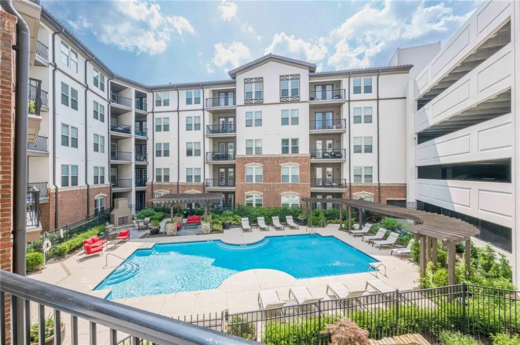 Community pool with a pergola and a patio