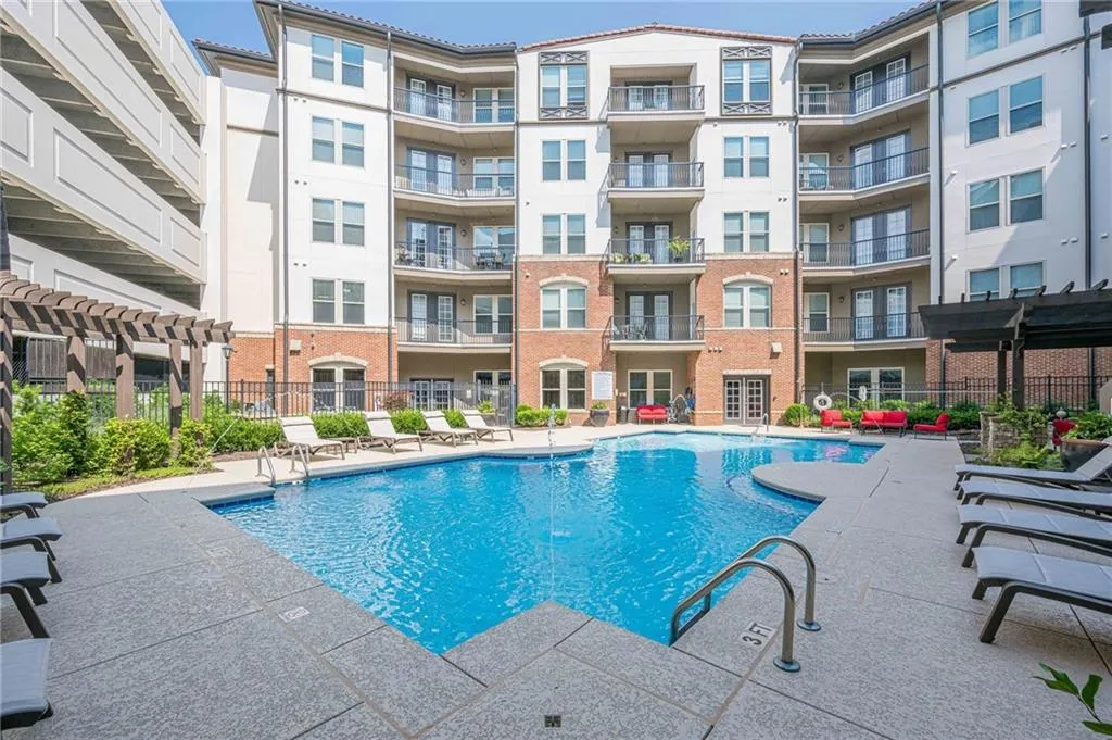 Community pool with a pergola and a patio area