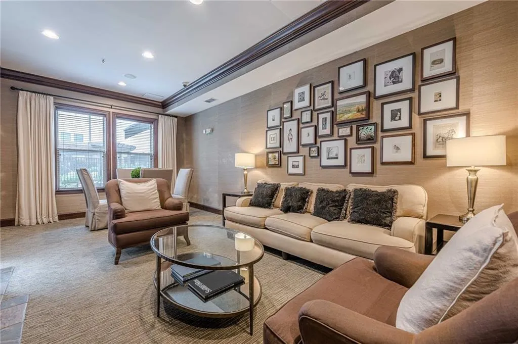 Carpeted living area featuring ornamental molding, recessed lighting, wallpapered walls, and a raised ceiling
