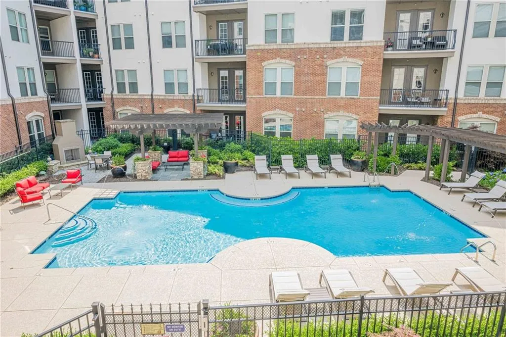 Community pool with a pergola and a patio
