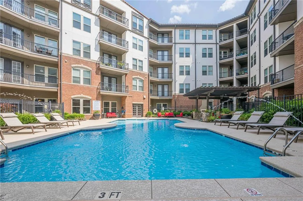 Community pool with a patio area