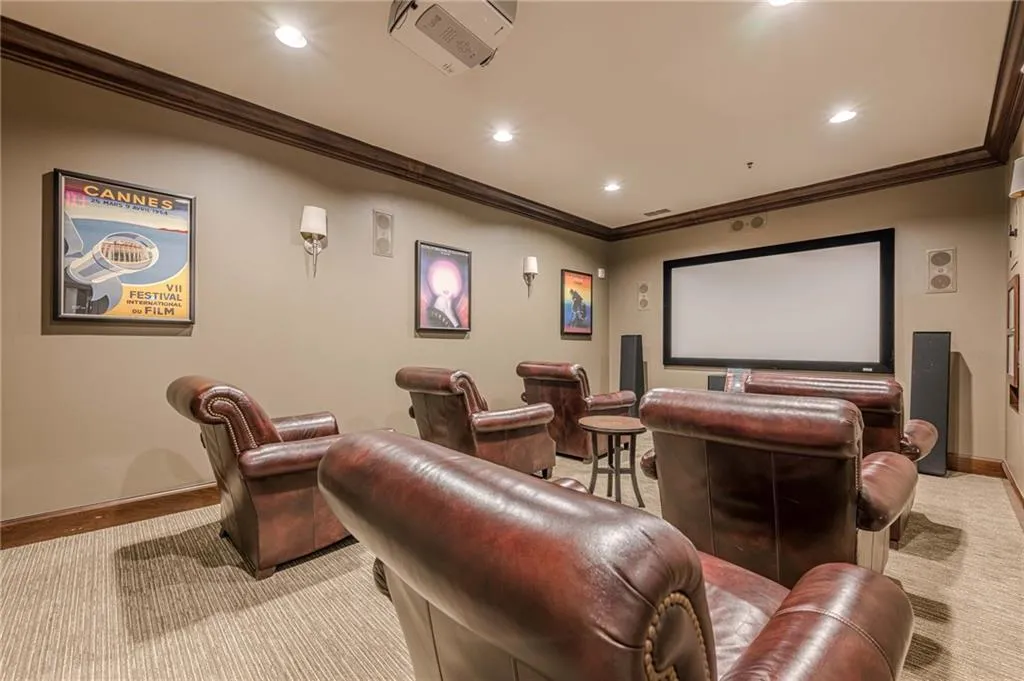 Home theater room featuring cooling unit, crown molding, and recessed lighting