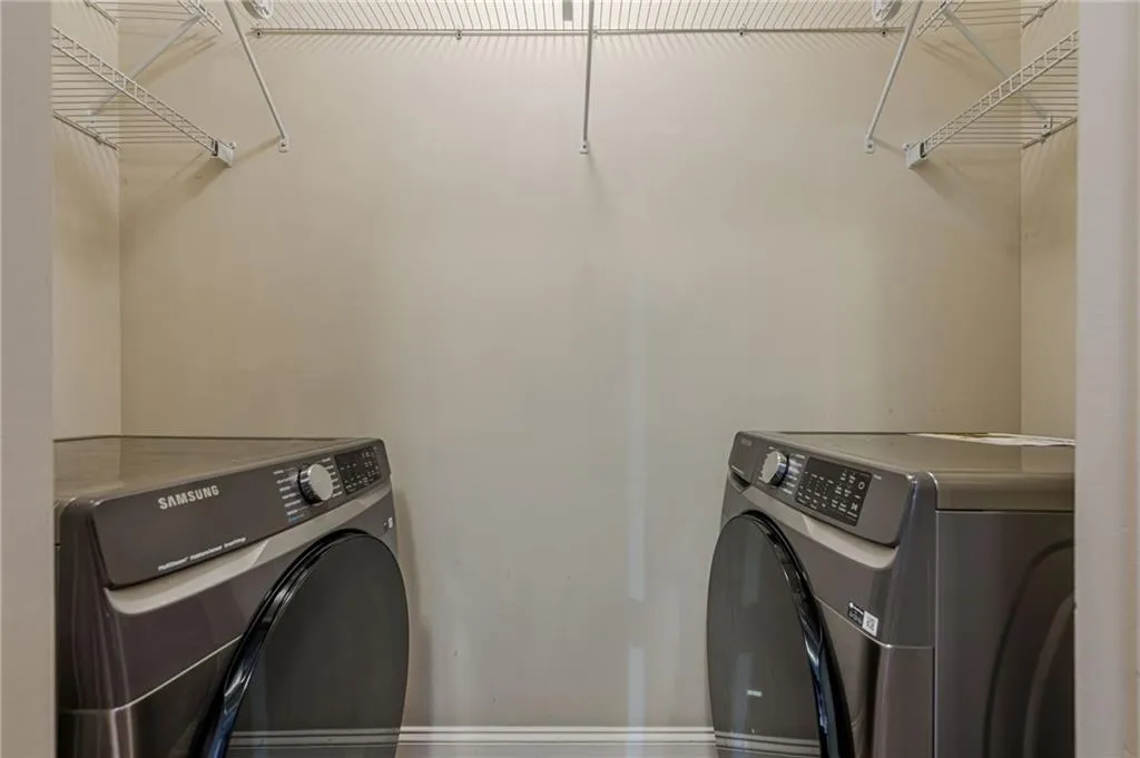 Washroom with washing machine and clothes dryer