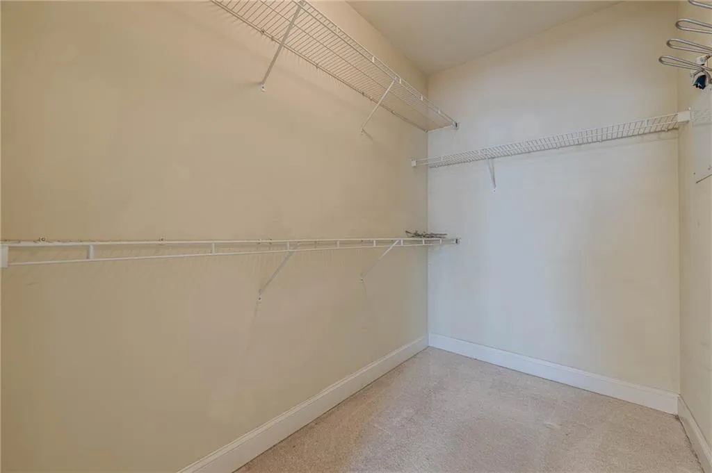 Spacious closet with light colored carpet