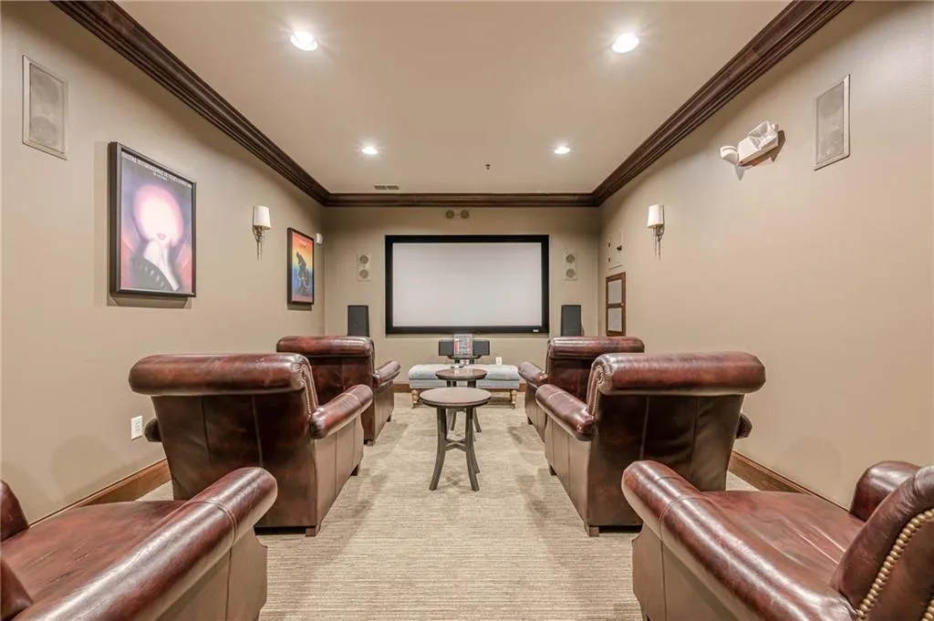 Cinema room with ornamental molding and recessed lighting