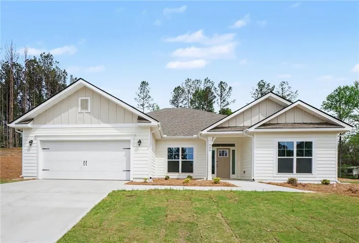 Contemporary ranch-style home featuring white horizontal siding and vertical board-and-batten gables