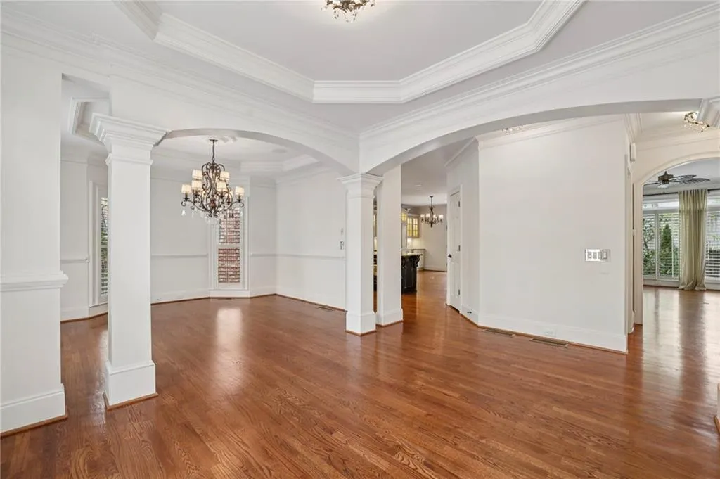 Living and dining room open to one other through architectural arches