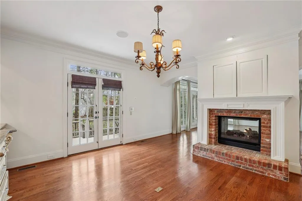 See-through gas fireplace and French doors to patio from the breakfast area