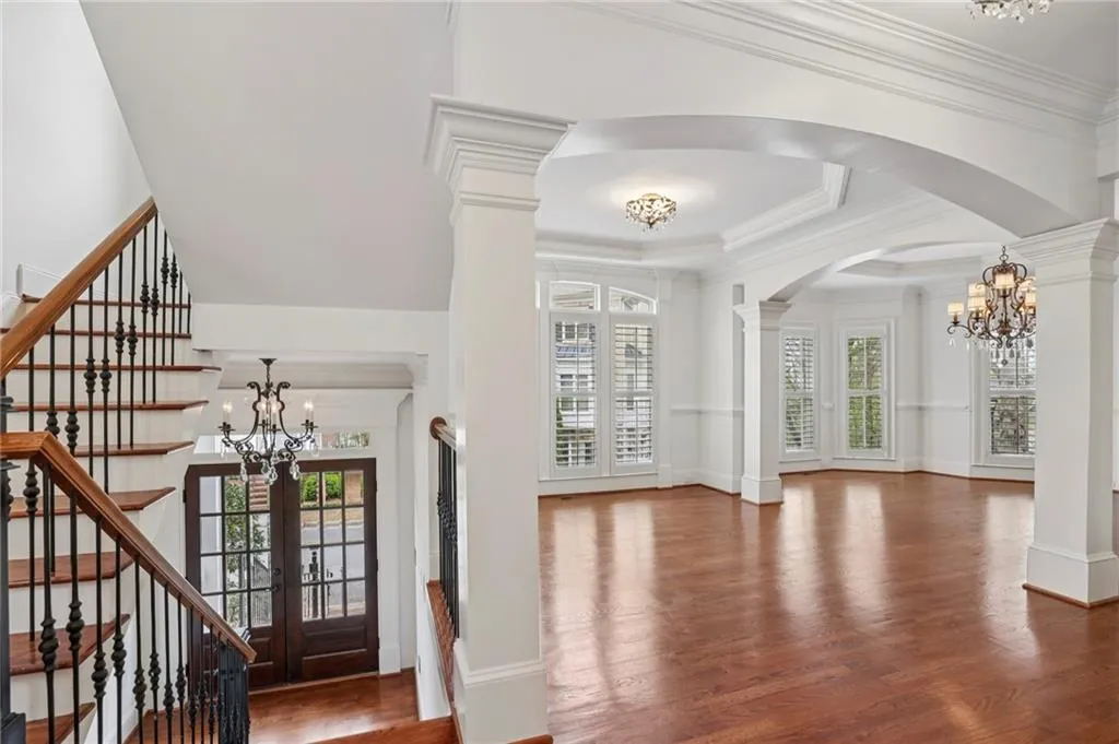 View into Living and dining rooms - beautiful moldings, arches, and hardwood floors