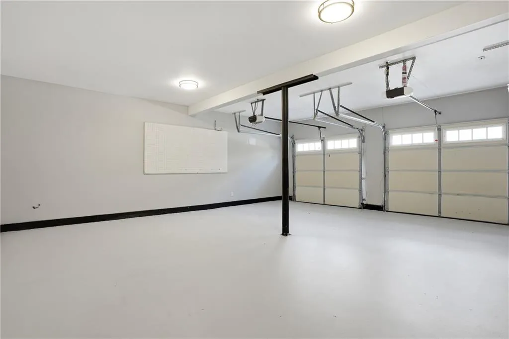 Garage featuring baseboards