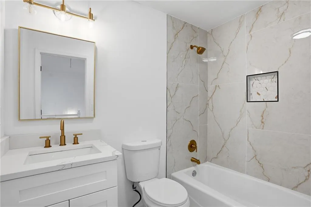 Bathroom featuring vanity and  shower combination