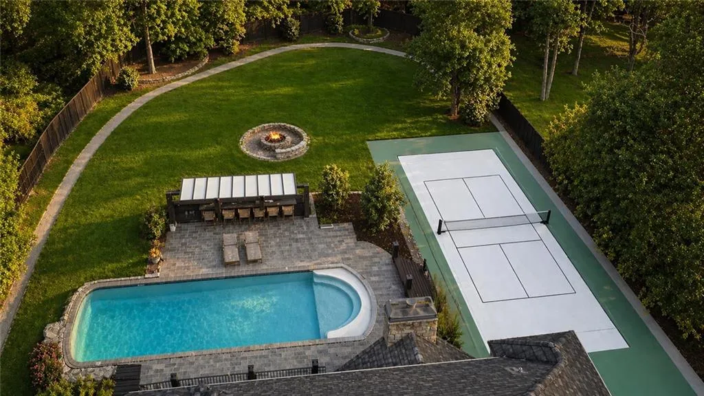 back yard with pool and pickleball court