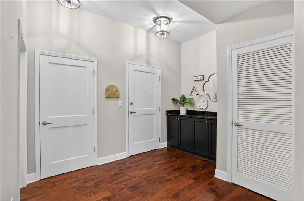 Entrance foyer featuring dark wood finished floors and baseboards