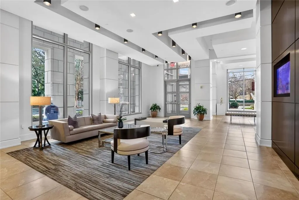 Lobby featuring a high tray ceiling and recessed lighting