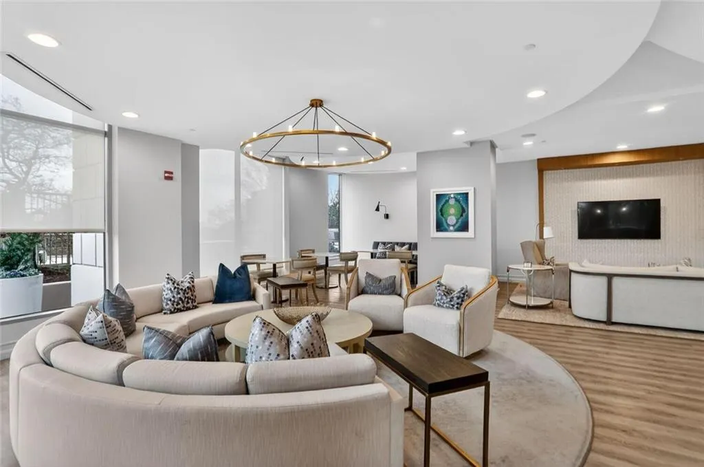 Living room featuring hanging lights and wood finished floors