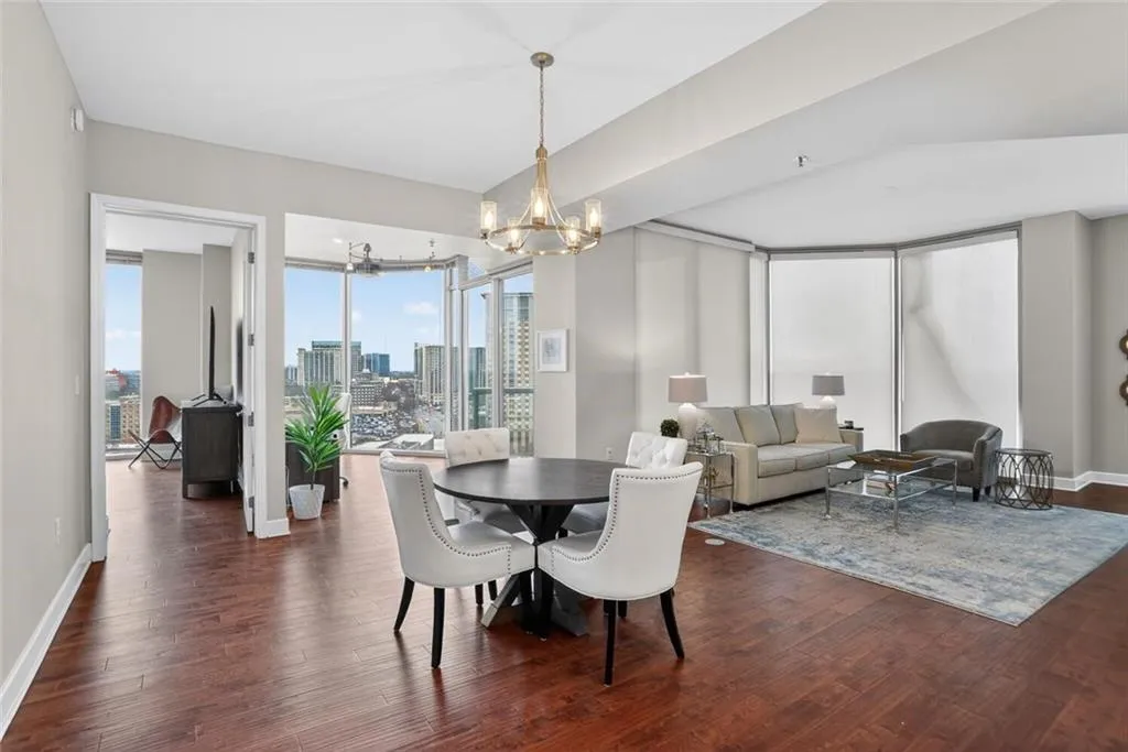 Dining area with dark wood-type flooring, a chandelier, and a view of skyline