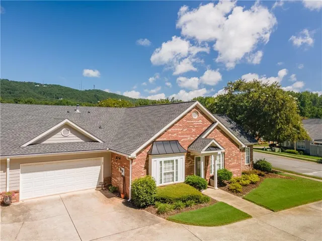 Brick and siding exterior with a shingled roof
