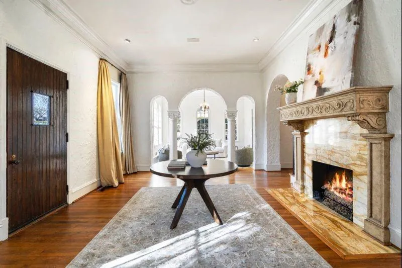 Foyer with marble and limestone fireplace