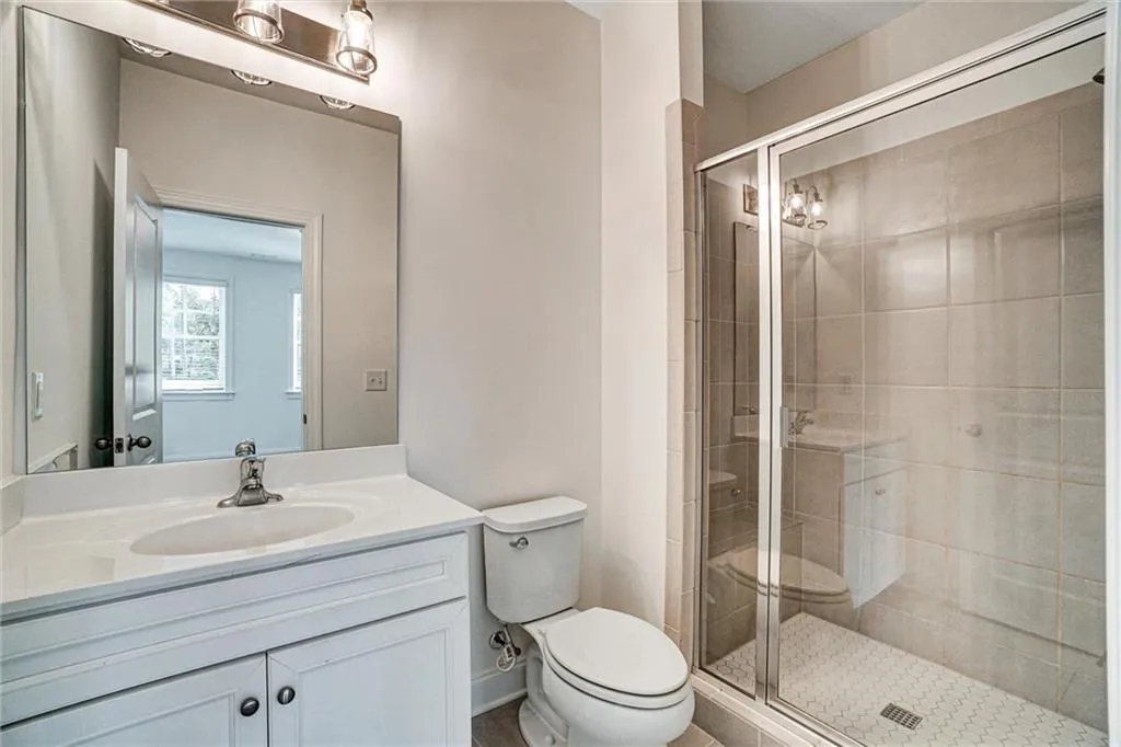 Bathroom with vanity and a shower stall