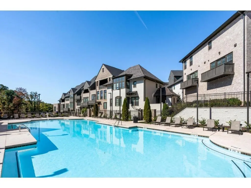 Community pool featuring a patio area and a residential view