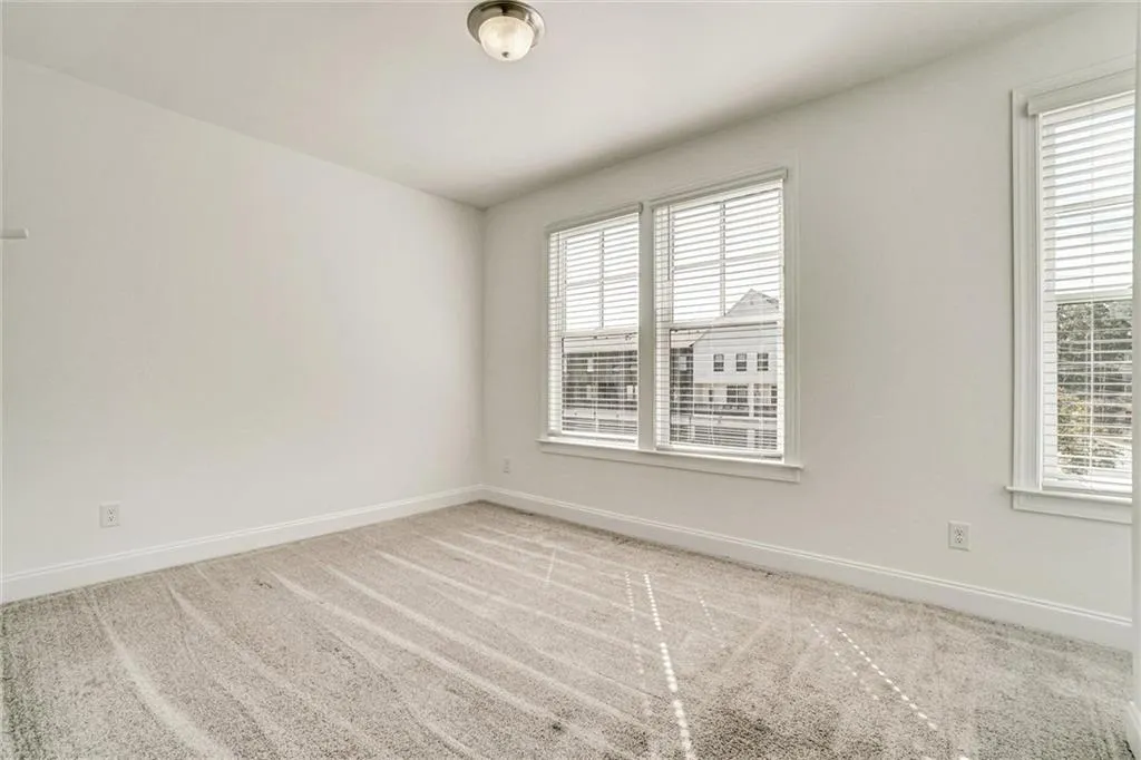 Spare room featuring light carpet and healthy amount of natural light