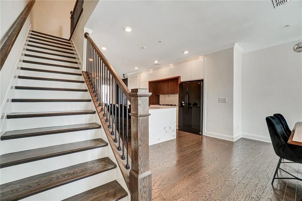 Stairs featuring recessed lighting, wood finished floors, and crown molding