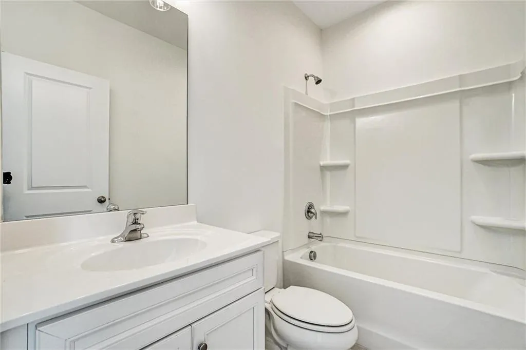 Full bath featuring vanity and shower / bath combination