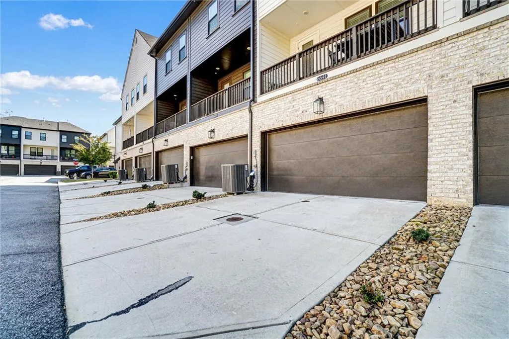 View of property featuring concrete driveway and an attached garage