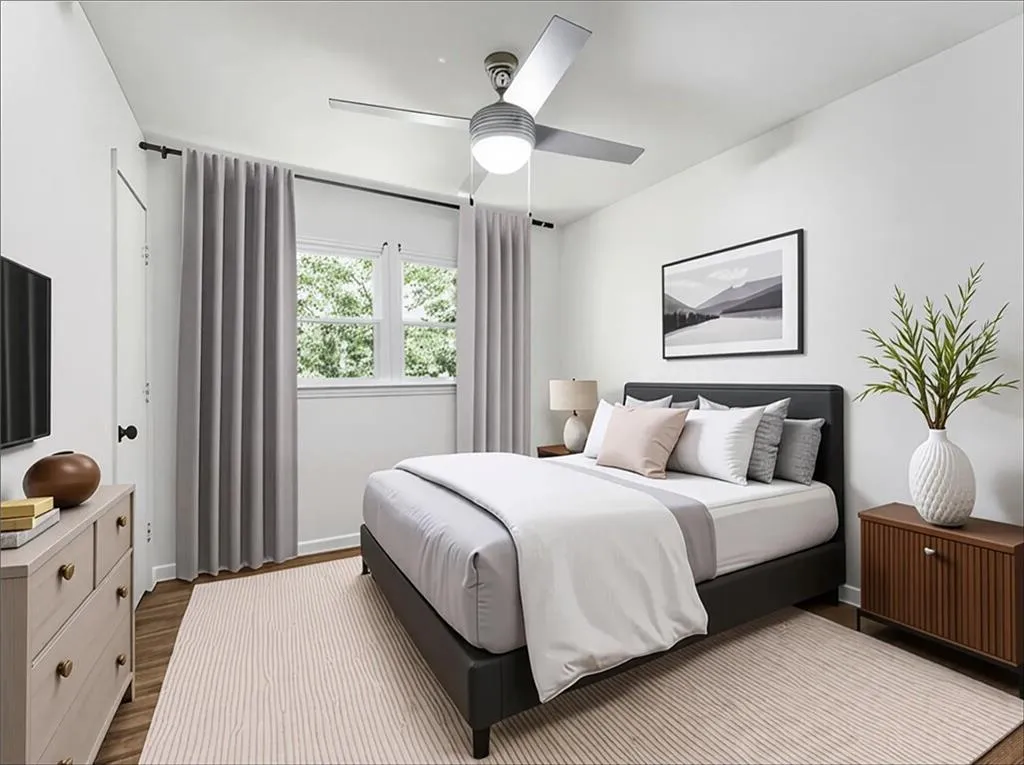 Bedroom featuring wood finished floors and a ceiling fan