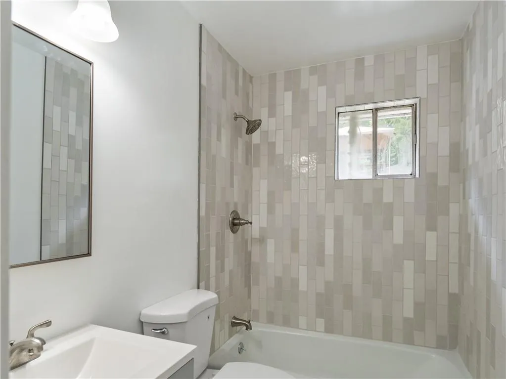 Bathroom with shower / bath combination and vanity
