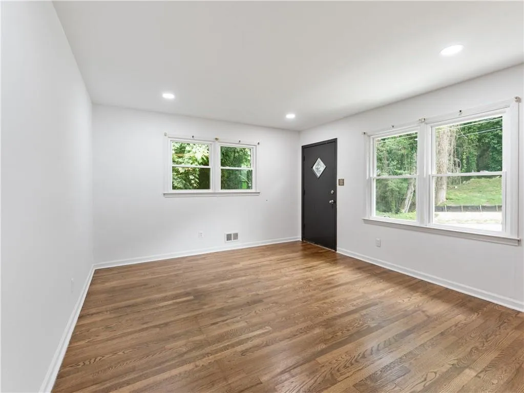 Foyer entrance featuring wood finished floors and recessed lighting