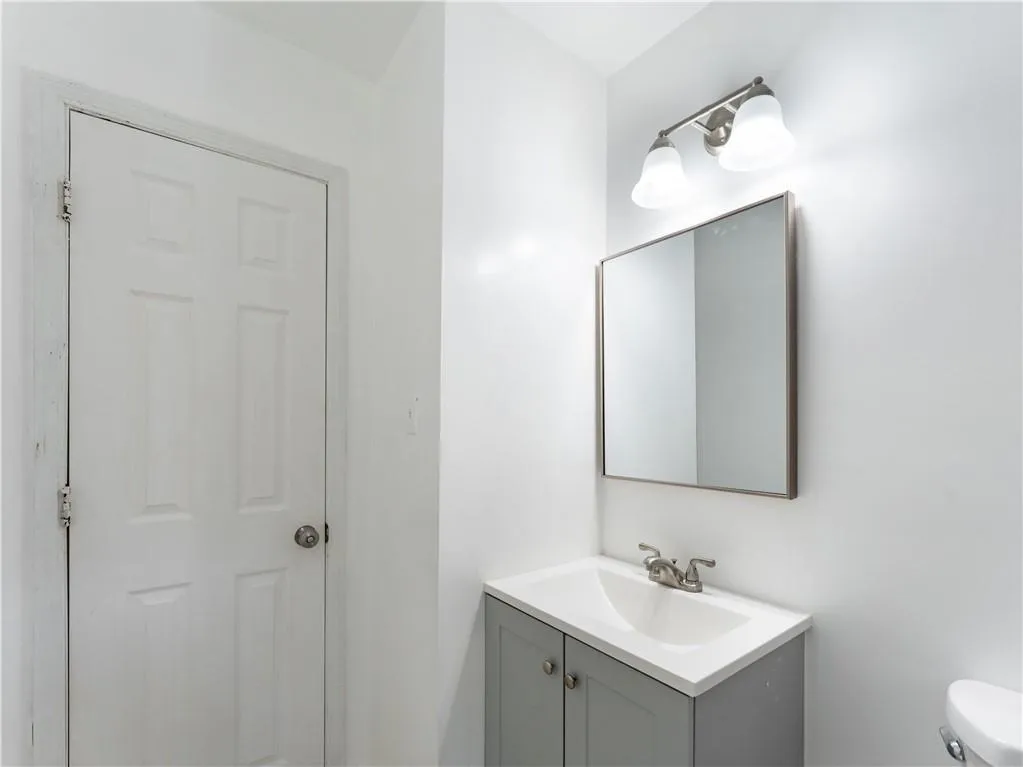 Half bath with vanity and toilet