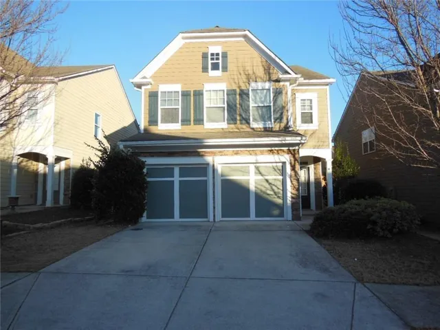 Two-story exterior with shake siding and a two-car garage