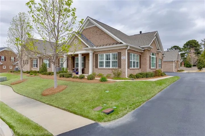 Front exterior with side-entry garage and manicured front lawn.