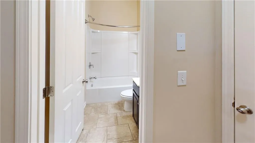 Terrace Level Full bathroom with toilet, shower / washtub combination, vanity, and tile patterned floors