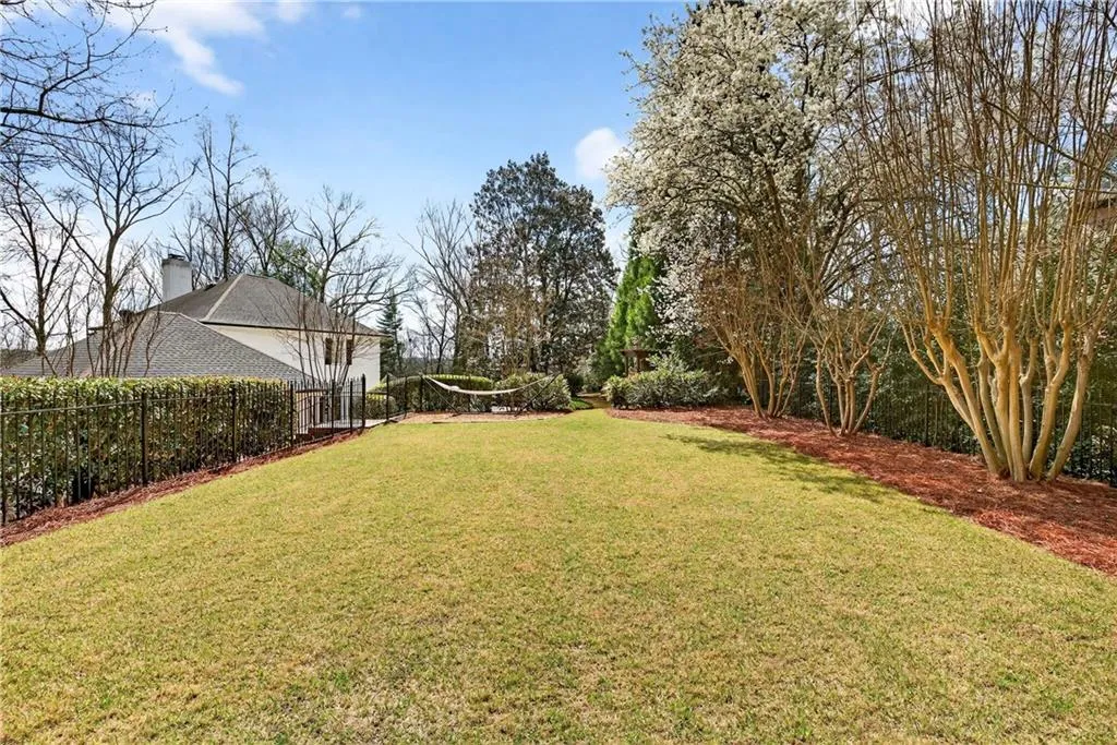 The upper yard is flat, usable, and well suited for a future pool if desired.