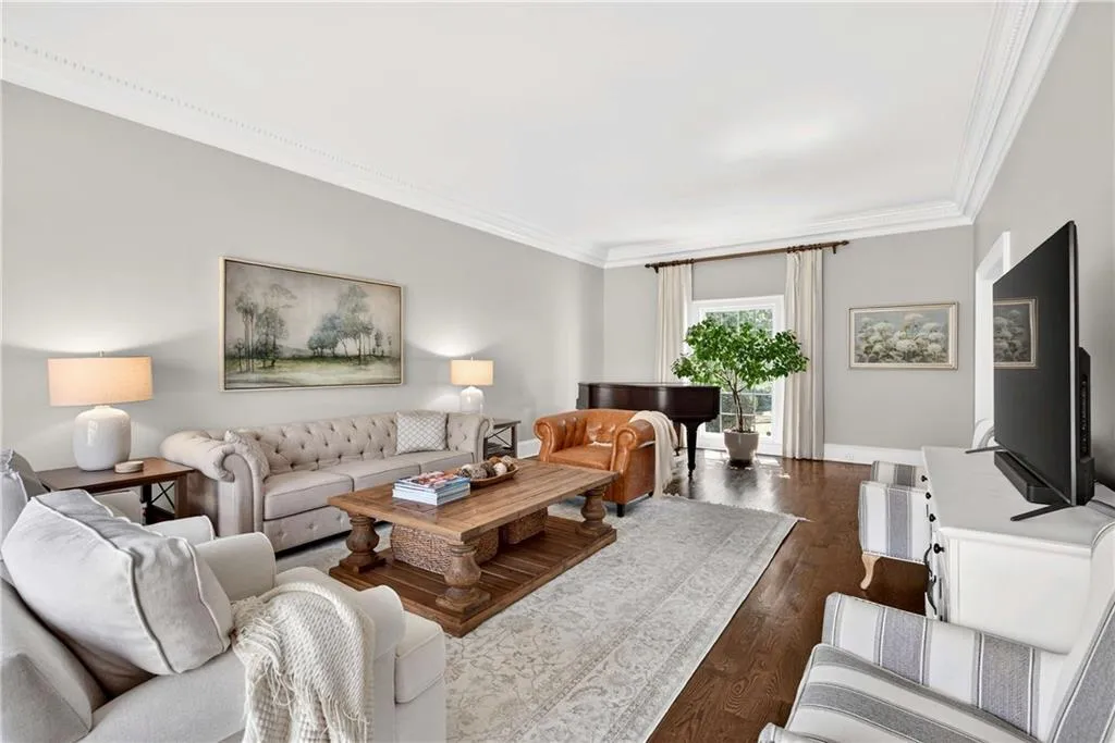 The formal living room is spacious and filled with natural light, creating an elegant and airy atmosphere. Its generous layout offers a wonderful setting for both entertaining and quiet enjoyment.