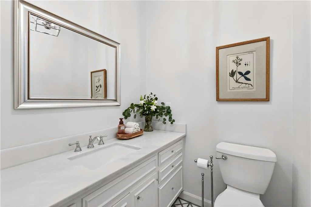 An updated guest half bath on the main level adds both style and convenience for everyday living and entertaining.