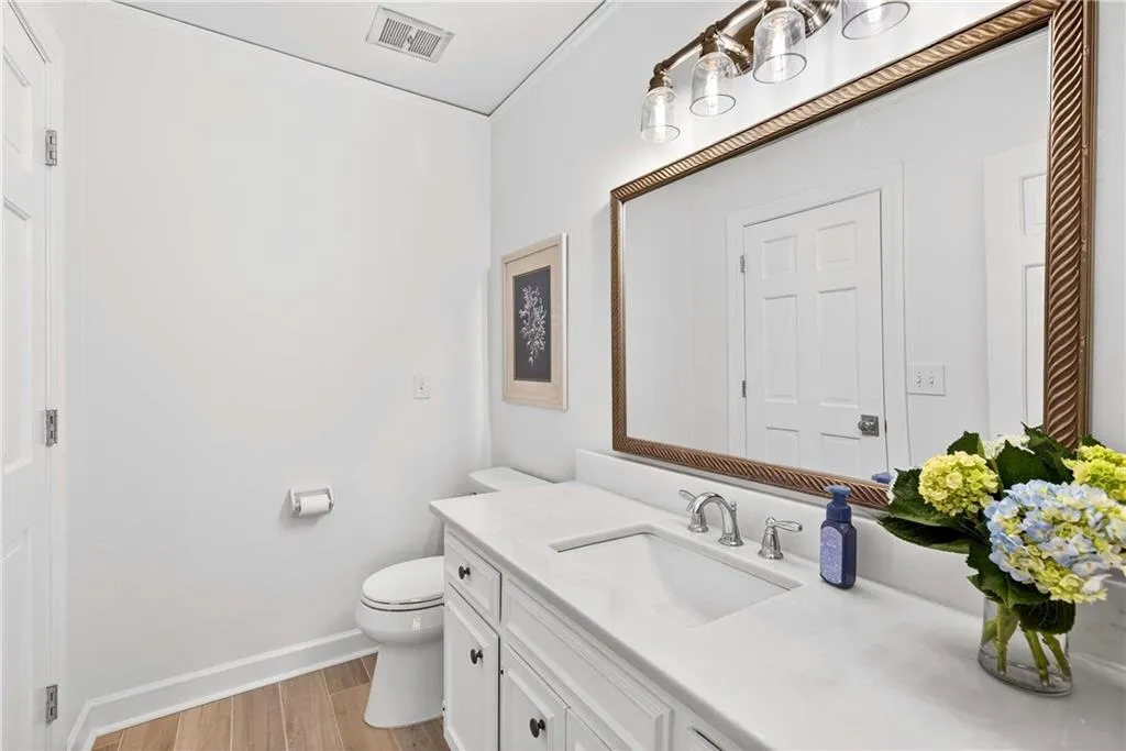 This updated bathroom shares a shower with the guest bath but is also en suite to an adjoing bedroom.