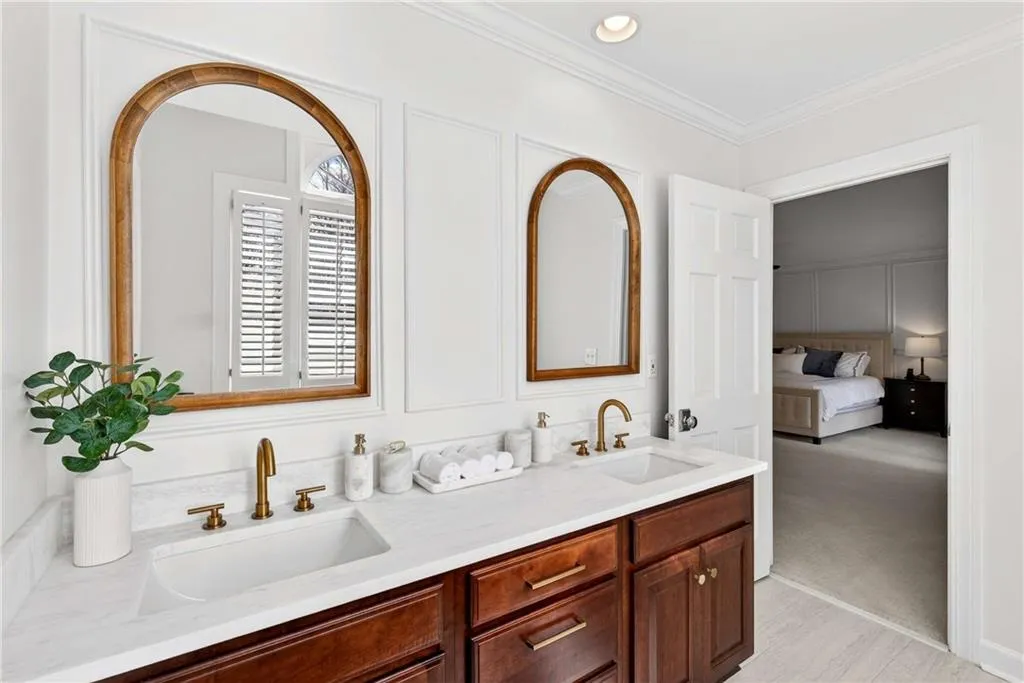 Filled with natural light, this bathroom features recessed lighting and beautiful new countertops that create a bright and polished feel.