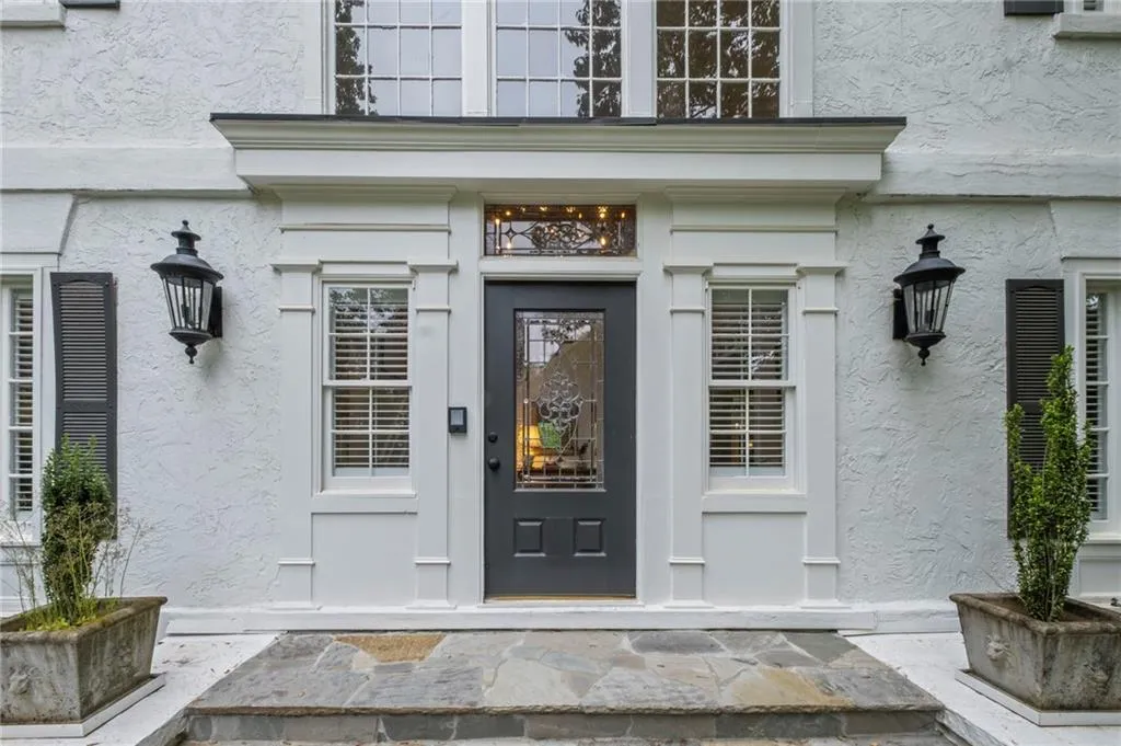 View of exterior entry with stucco siding