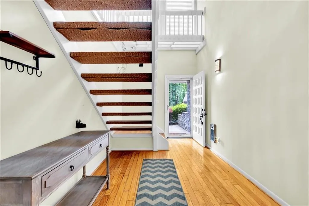 Entrance foyer featuring wood-type flooring and a high ceiling