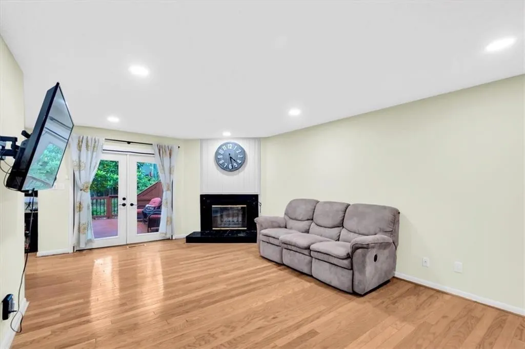 Living room featuring light hardwood / wood-style floors, french doors, and a fireplace