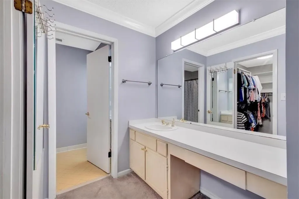 Bathroom featuring tile flooring, ornamental molding, and vanity