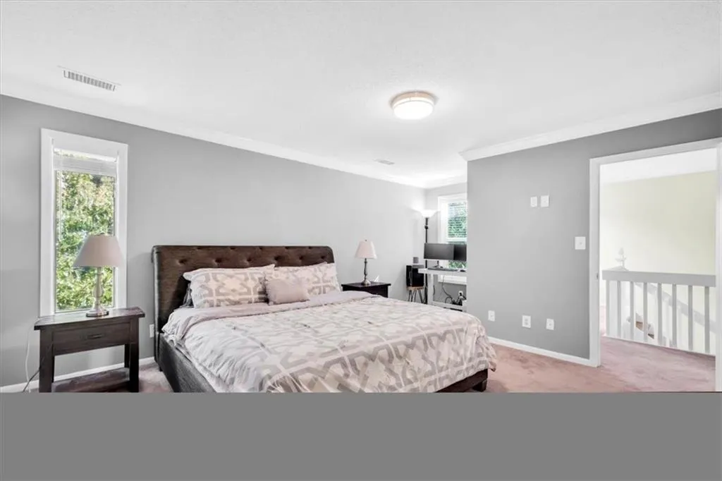 Carpeted bedroom featuring ornamental molding