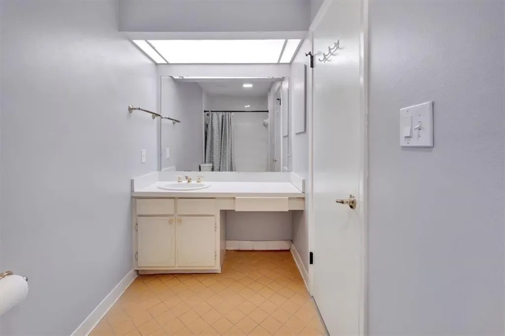 Bathroom with tile flooring and vanity