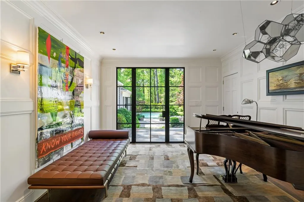 Sitting room featuring a decorative wall and ornamental molding