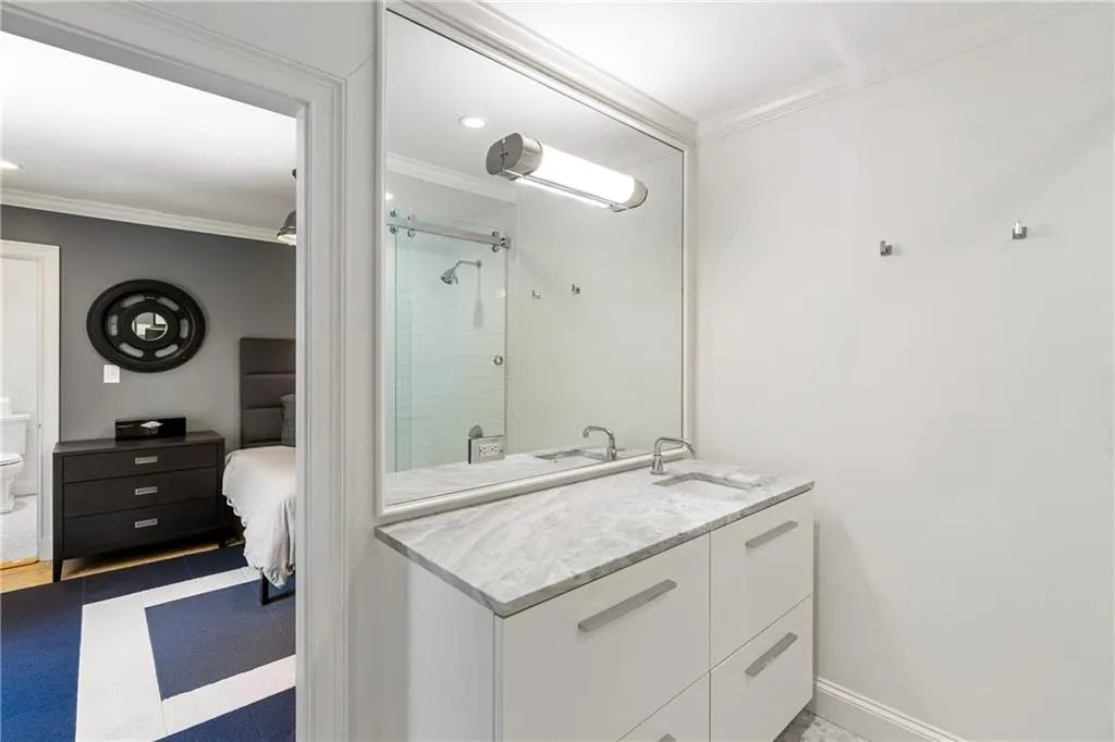 Full bath with crown molding, a shower stall, vanity, toilet, and tile patterned floors