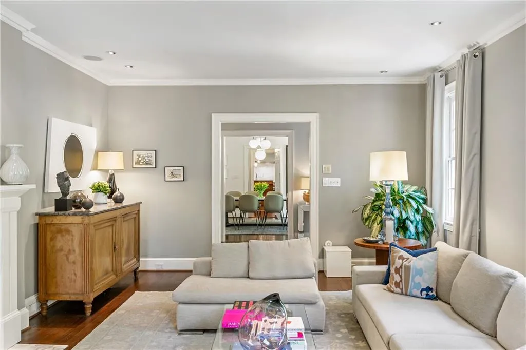 Living area featuring wood finished floors, crown molding, baseboards, and recessed lighting